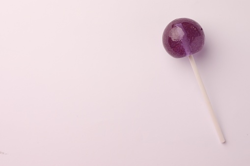 Tasty lollipop on white background, top view. Space for text