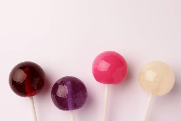 istock Tasty lollipops on white background, flat lay. Space for text 1668537692