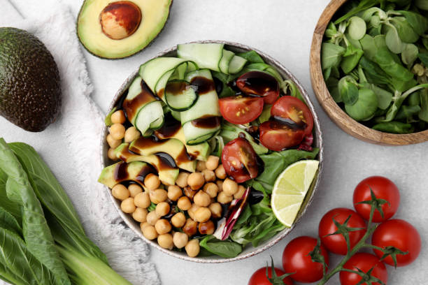 istock Delicious salad with balsamic vinegar and ingredients on white table, flat lay 1668545742