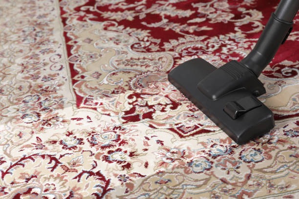 Hoovering carpet with vacuum cleaner, space for text. Clean trace on dirty surface