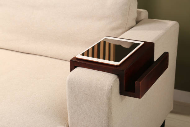 istock Tablet on sofa armrest wooden table in room. Interior element 1668554869