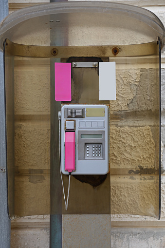 Old Public Payphone With Pink Handle in Working Order Communication