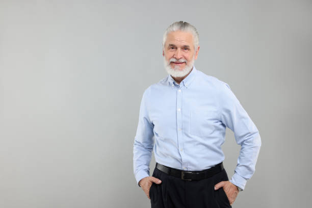 istock Portrait of handsome senior man on light grey background. Space for text 1668574860