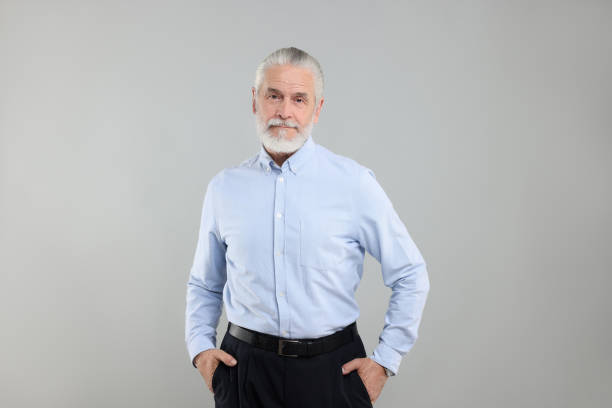 istock Portrait of handsome senior man on light grey background 1668574863