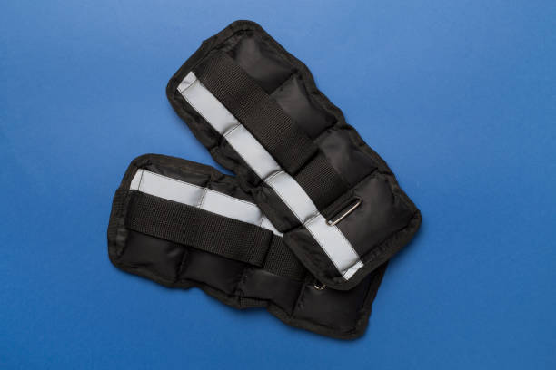 istock Fitness wrist and ankle weights on color background, top view 1668590813