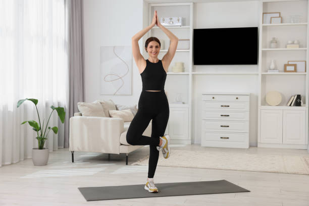 istock Happy woman doing morning exercise at home 1668591381