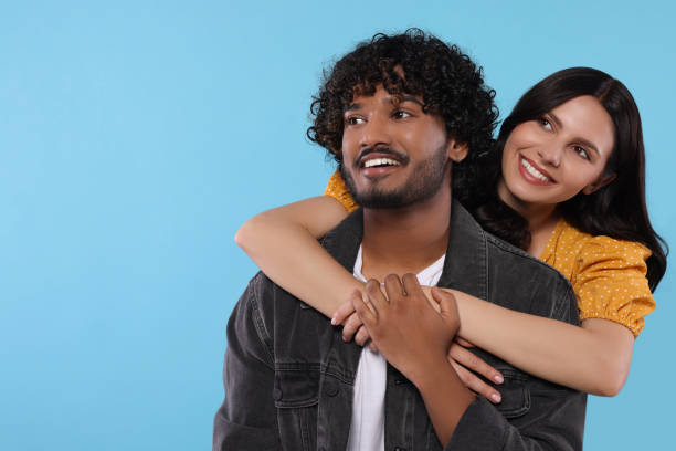 istock International dating. Happy couple hugging on light blue background, space for text 1668609596