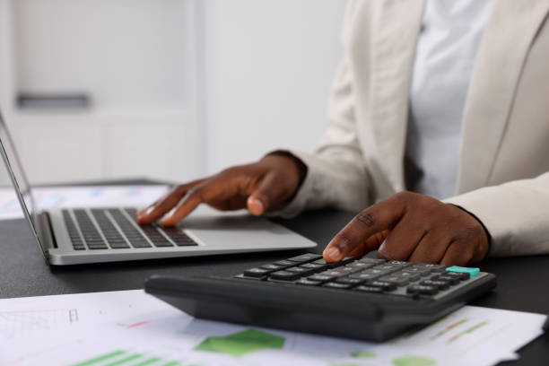 istock Professional accountant working at desk in office, closeup 1668610136