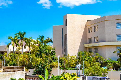 Modern buildings and architecture hotels resorts and apartments in tropical paradise with palm trees in Playa del Carmen Quintana Roo Mexico.