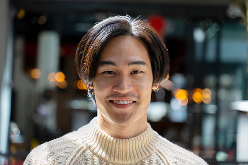 Closeup portrait of smiling asian man looking at camera. Attractive positive japanese student posing for picture, advertisement