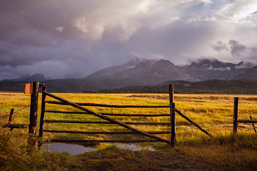 Farm gate against Sawtooth Mountain backdrop in Stanley, Idaho