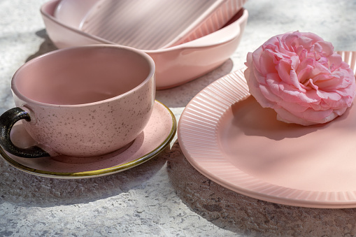 Fragment of set of serving dishes. Fashionable pink color.