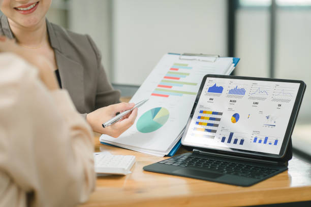 istock Businesswoman advisor team are analyzing data charts, graphs, and a dashboard on a laptop screen in order to prepare a statistical report and discuss financial data in an office. 1668744026