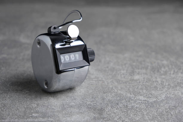 istock Metal, retro mechanical hand counter gray concrete background. 1668807387