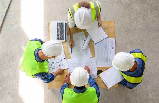 istock top view of engineers team meeting and discussing by using laptop,blueprint and documents on table in the building under construction,project manager consultation meeting with coworker 1668821385