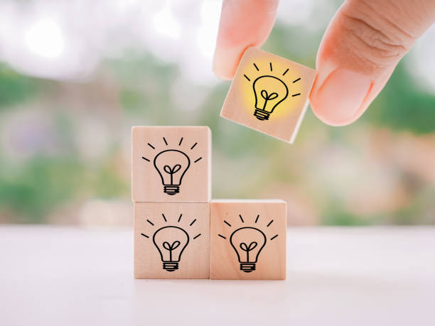 istock Close up hand arranging wooden block with light bulb for leadership, creative, idea, innovation concept. 1668914181
