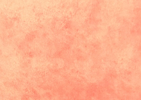 light red or beige watercolor background Primed with rough human skin tones. Pastel watercolor primer. Light red.