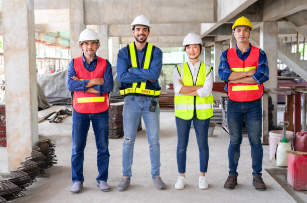 istock engineering teamwork in full safety gear,standing arms crossed,in the building under construction that filled with many construction equipment 1668997453