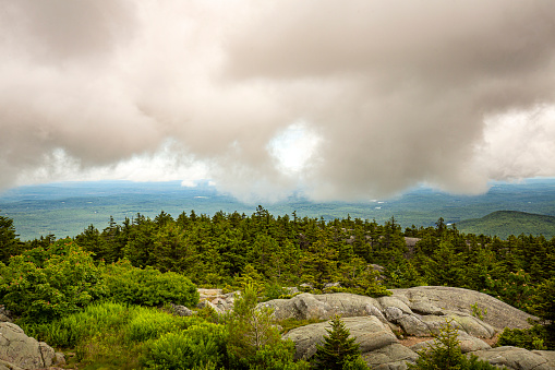 Passing dark rain cloud floating by, seen from the summit of Mt. Kearsarge, at Winslow State Park in Wilmot, New Hampshire