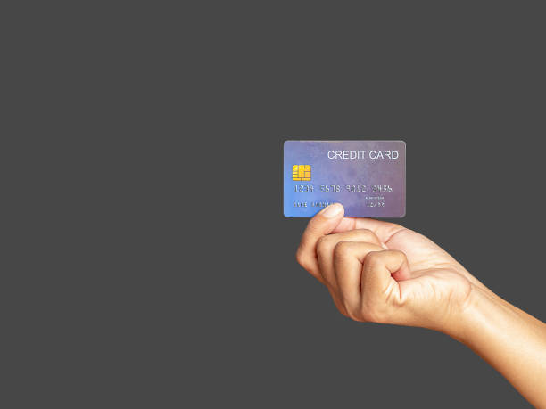 istock Hand of holding a mockup blue credit card while standing with gray background 1669072177