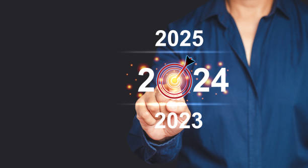 istock Businessman pointing to digital 2024 calendar on virtual screen while standing on a gray background 1669072697