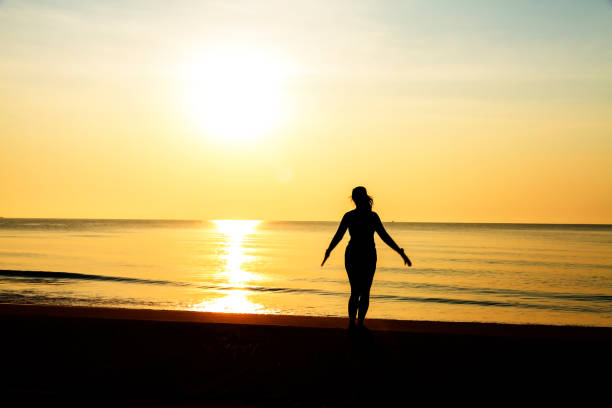 istock Woman exercise with sunrise at beach Bang Boet 1669083581