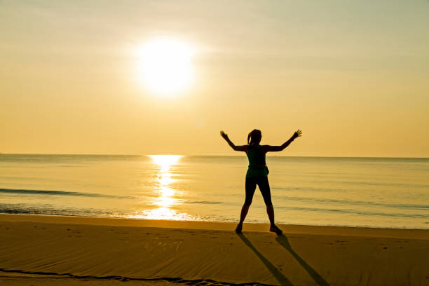 istock Woman exercise with sunrise at beach Bang Boet 1669083583