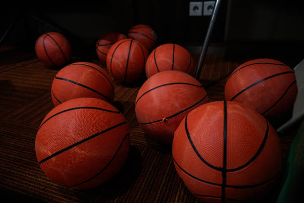 istock some basketballs scattered on the floor 1669084255