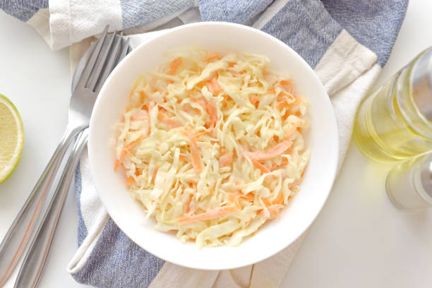 istock Coleslaw salad with carrot and cabbage in a white bowl. 1669085164