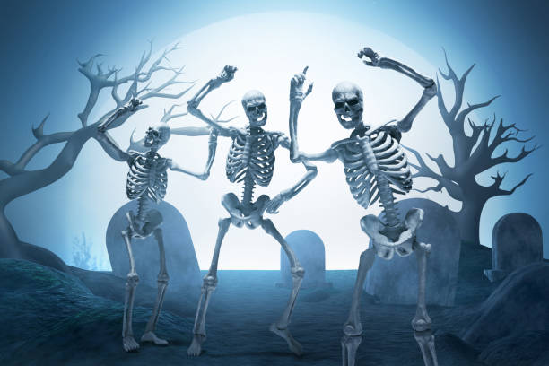 istock Group of funny human skeleton dancing on graveyard cemetery with full moon background 1669119746