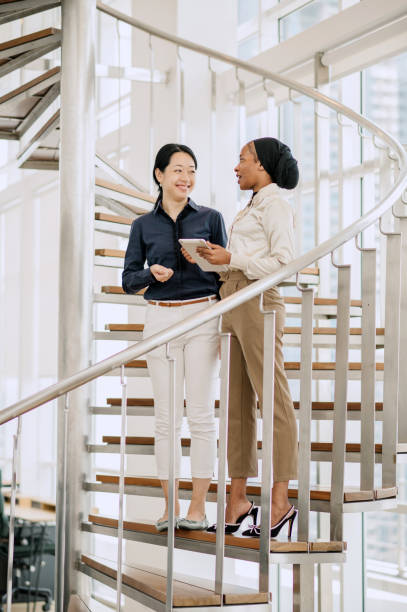 istock Two multiracial businesswomen talking in office. 1669124038