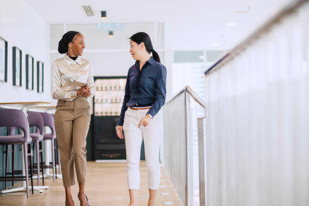 istock Two multiracial businesswomen talking in office. 1669124068