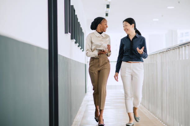 istock Two multiracial businesswomen talking in office. 1669124586