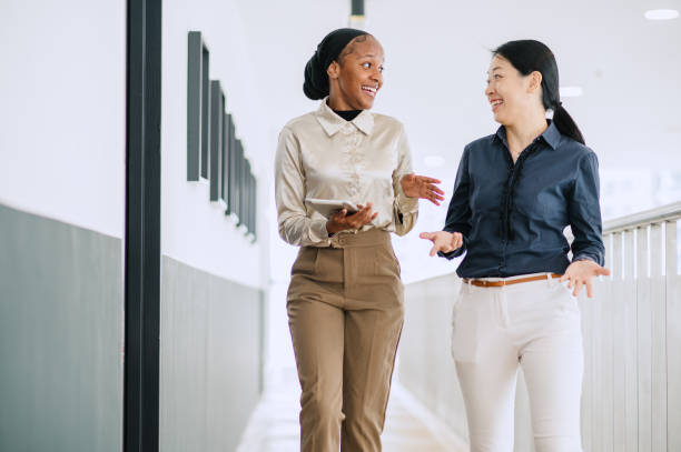 istock Two multiracial businesswomen talking in office. 1669125103