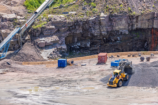Falköping, Sweden-July, 2022: Loader tipping gravel into a pile at a quarry