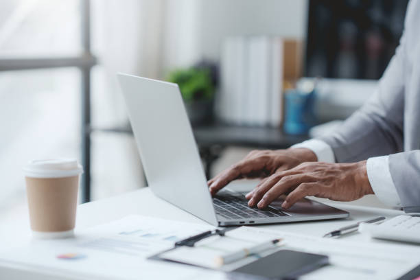 istock Business man sitting using laptop computer with on the desk in the office. 1669150950