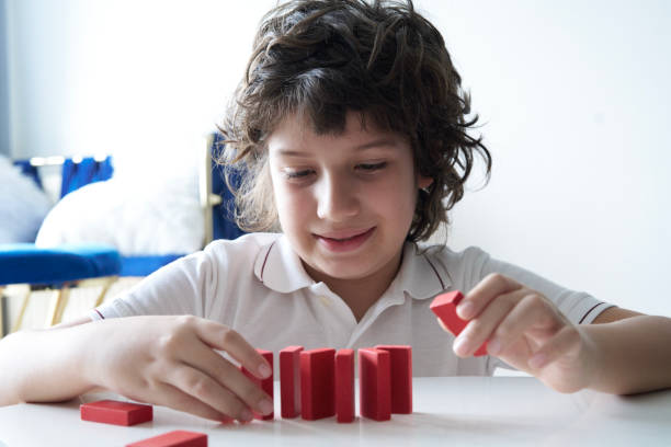 istock Cute Little Boy Playing with wooden block 1669179182