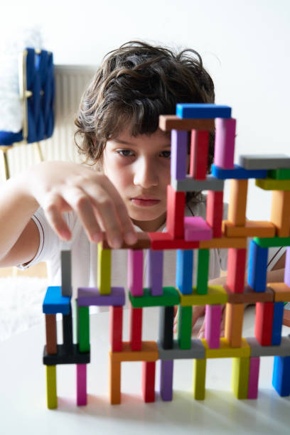 istock Cute Little Boy Playing with wooden block 1669181119