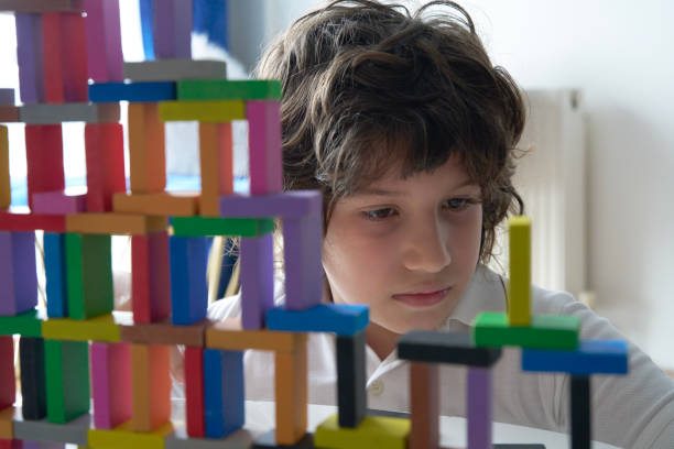 istock Cute Little Boy Playing with wooden block 1669182950