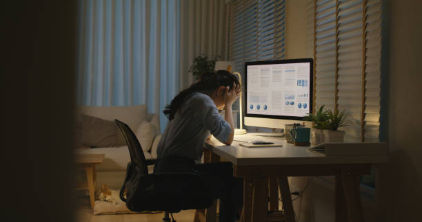 Asia people young woman study hard overnight brownout bored remote learn online read data tired sitting head in hands at home office desk workplace think worry in job tough stress workforce issue.