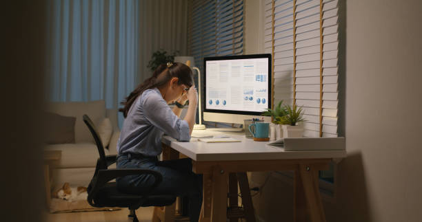 istock Asia people young woman study hard overnight brownout bored remote learn online read data tired sitting head in hands at home office desk workplace think worry in job tough stress workforce issue. 1669218236