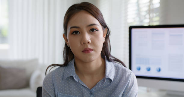 istock Future of workforce challenge in asia people, struggle remote work at home office desk workspace look at camera tired bored sad upset moody young female worker. Stress tension life crisis bad news. 1669219316