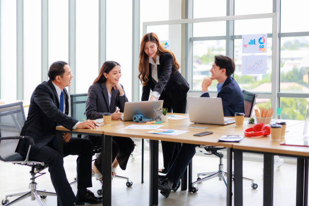 istock Professional Asian Colleagues in a Contemporary Office Setting, Strategizing for Corporate Growth and Efficiency 1669221944