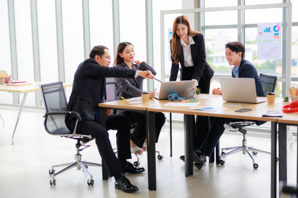 istock Professional Asian Colleagues in a Contemporary Office Setting, Strategizing for Corporate Growth and Efficiency 1669221948