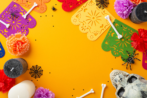 Embrace the spirit of Dia de los Muertos with this festive celebration concept. From above, capture the intricate details of various decor on a yellow isolated background. Perfect for messages or ads
