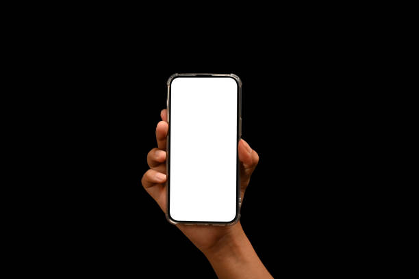 istock Hand holding smartphone isolated on black background. Empty screen for your text message or application design 1669276294