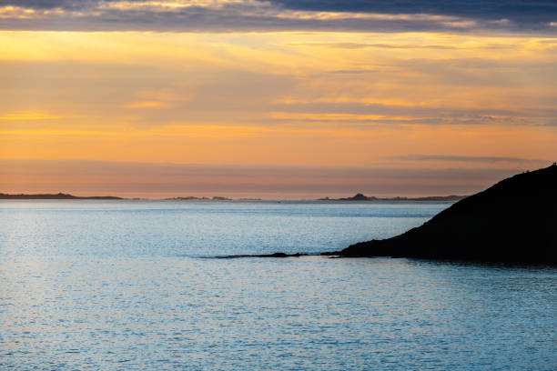 Silhouette of the Galician coast at the opening of the Ria de Pontevedra and the Ria de Arousa at dusk, were the Atlantic ocean meets the land.