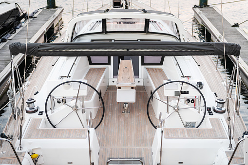 View of the dashboard on the deck of a luxury sailing yacht, as seen from the stern.