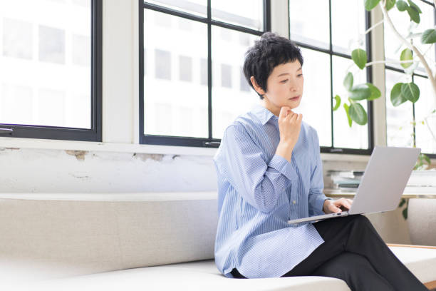 istock A middle-aged Asian woman is working on a computer. 1669443839