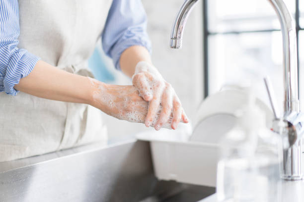 istock A woman is washing her hands in the kitchen. 1669474727